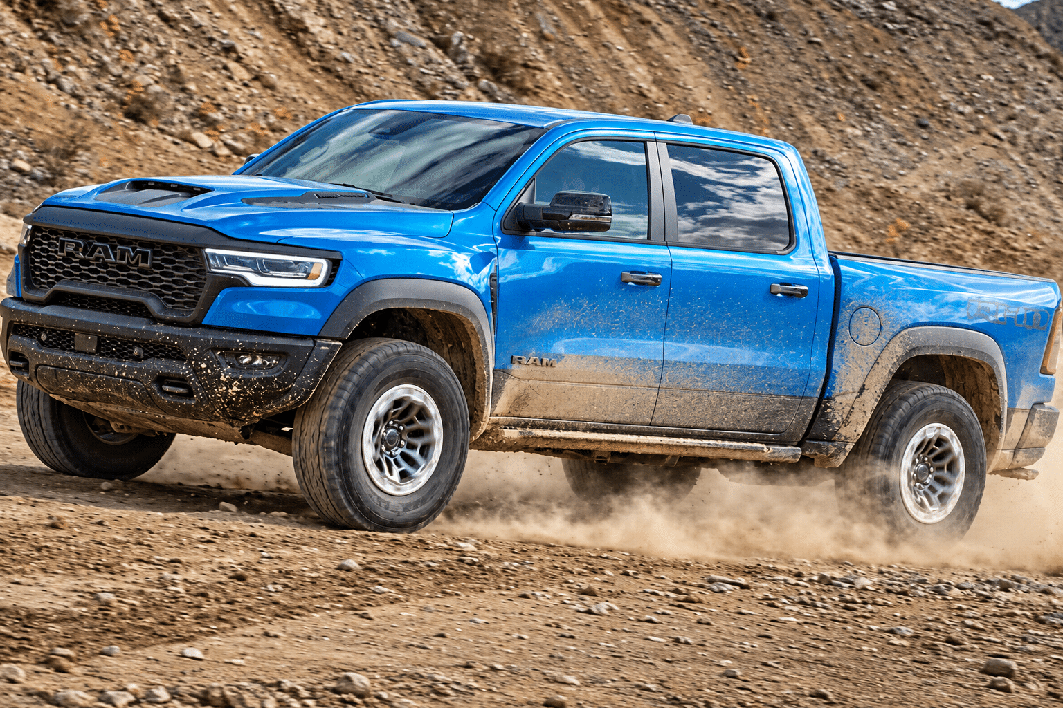 Blue pickup truck driving on a rugged dirt road, showcasing off-road capability.